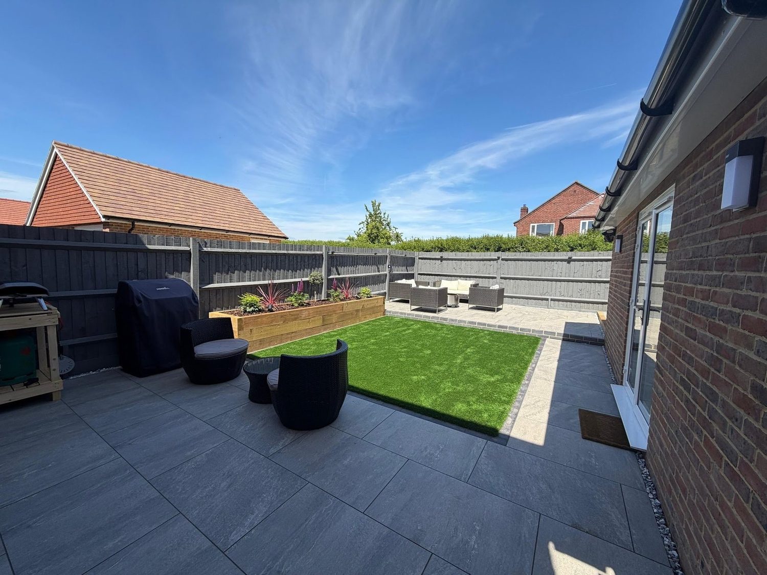 Finished new-build garden in Warsash by Etonic Landscapes, porcelain terrace and framed lawn