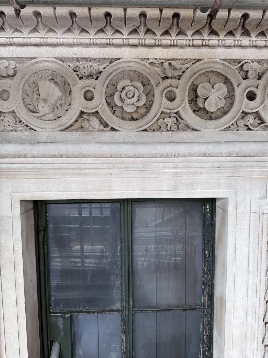 Cleaned Portland stone frieze with carved medallions, City of London
