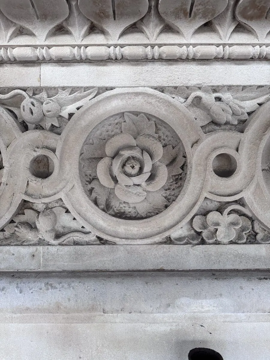 Close-up of carved Tudor rose medallion, cleaned Portland stone
